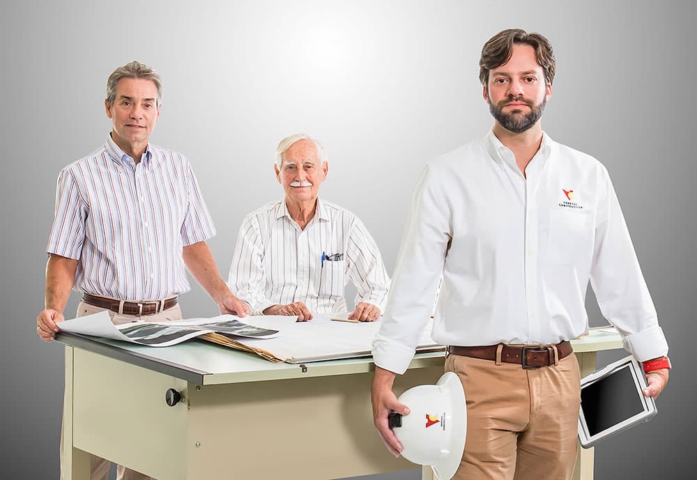 Three generations of Venegas Construction leadership at the drafting table
